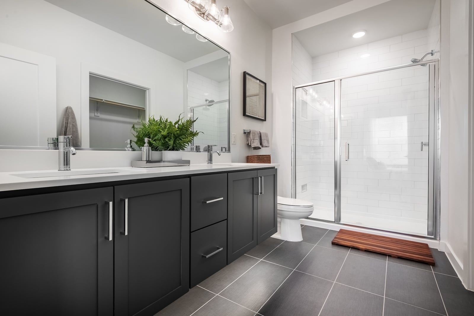 The Artesian at Bee Cave bathroom with double vanity and glass door shower