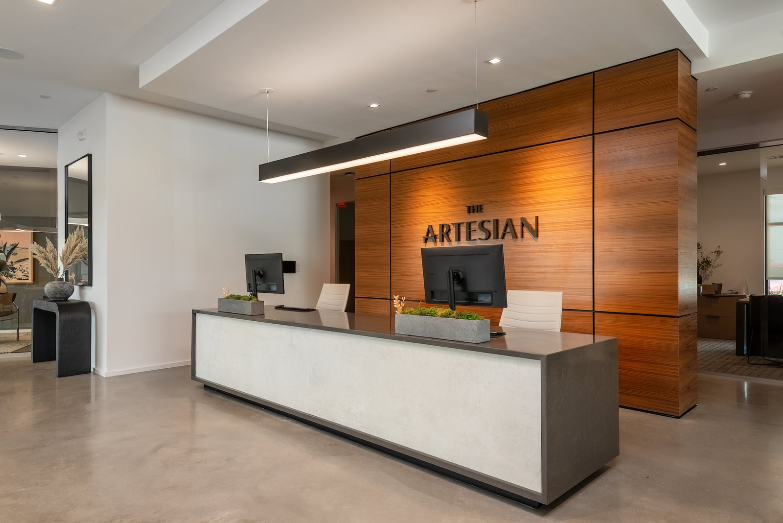 The Artesian at Bee Cave leasing lobby front desk with wood paneled wall