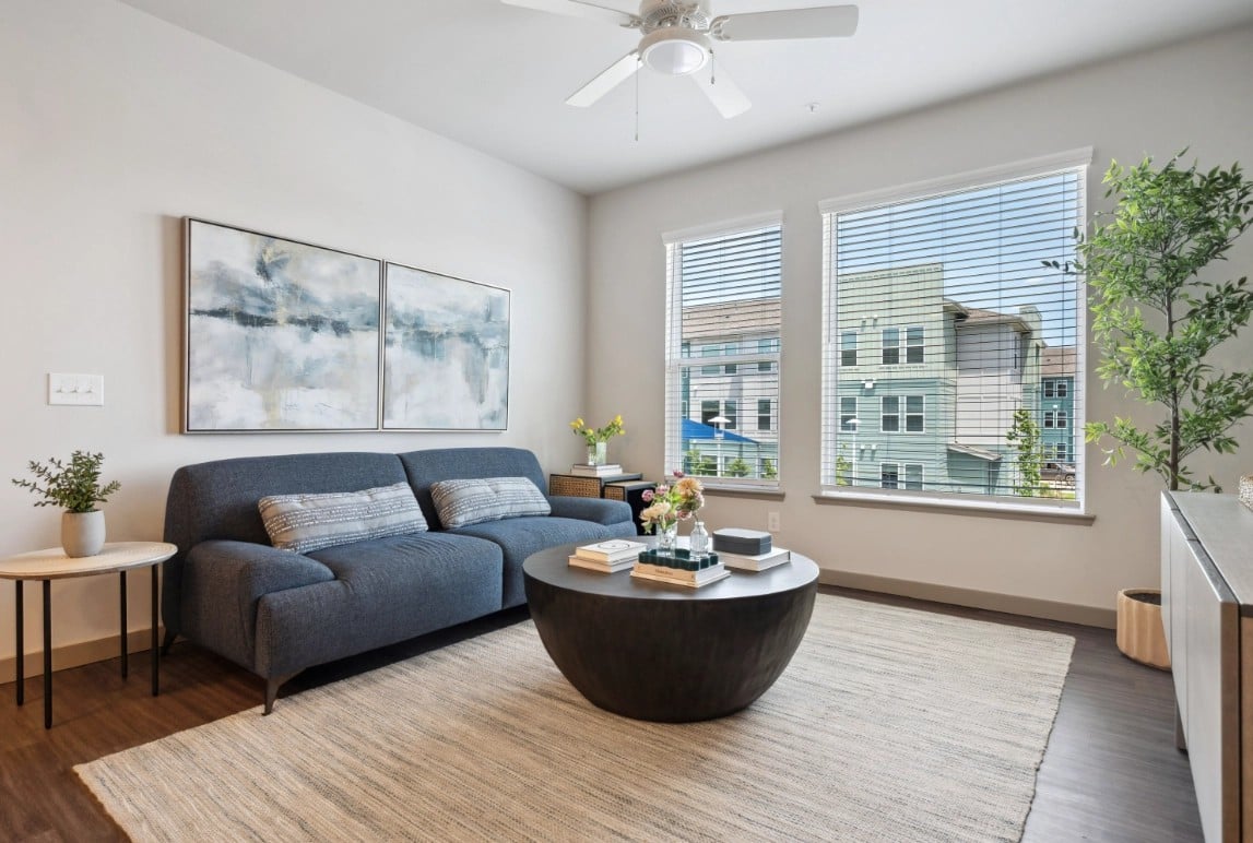 Berry model living room with two tall windows and a courtyard view
