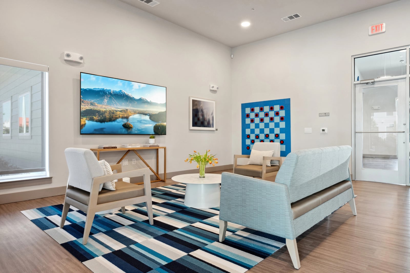 Berry resident lounge with TV wall and patterned rug