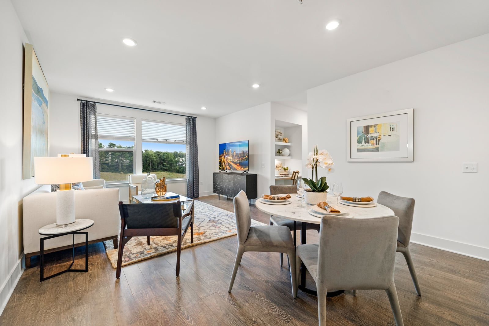 Colony Place open-concept living and dining room with wood-style flooring