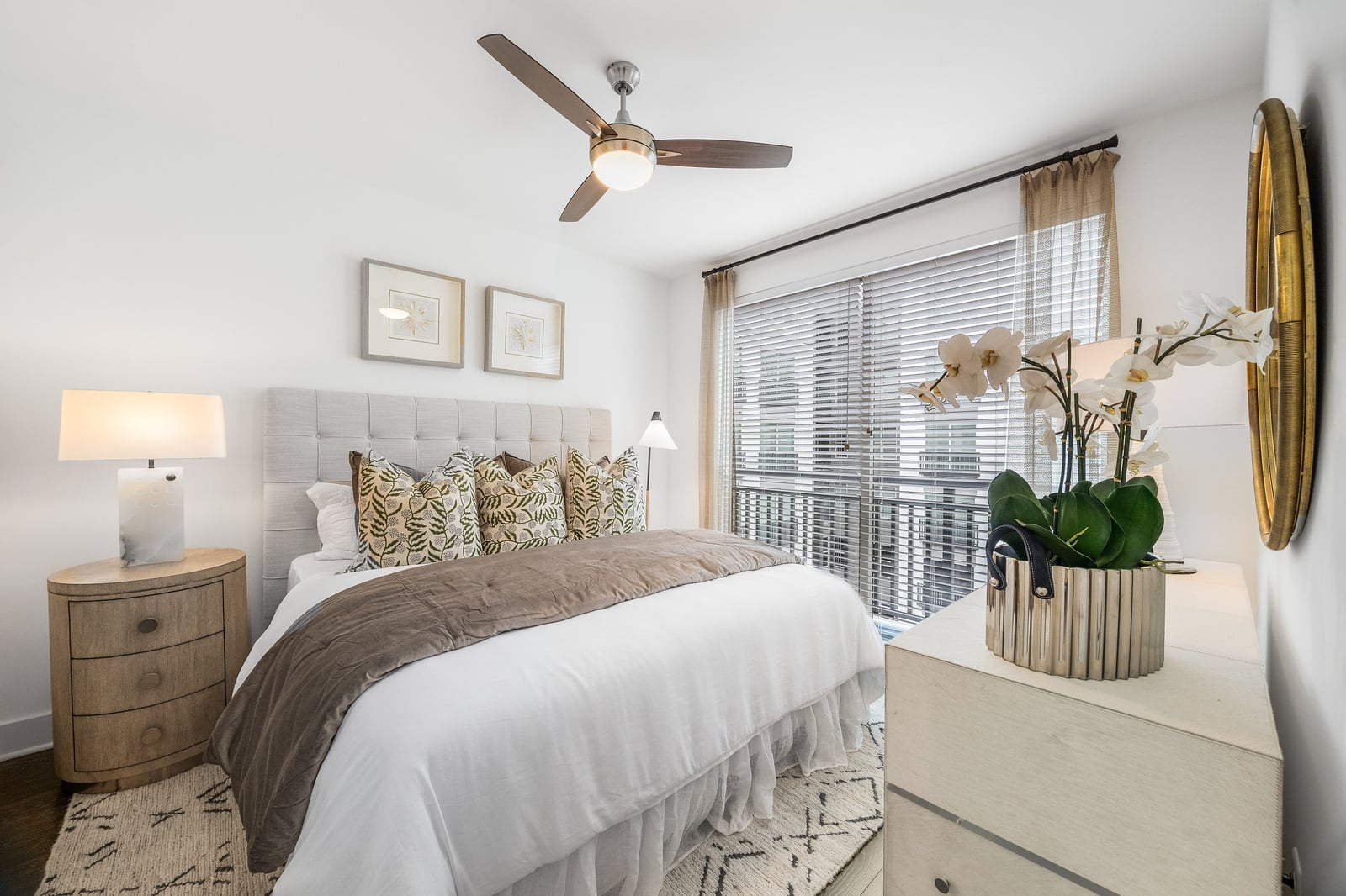 Edgewood bedroom with tufted headboard, ceiling fan and balcony