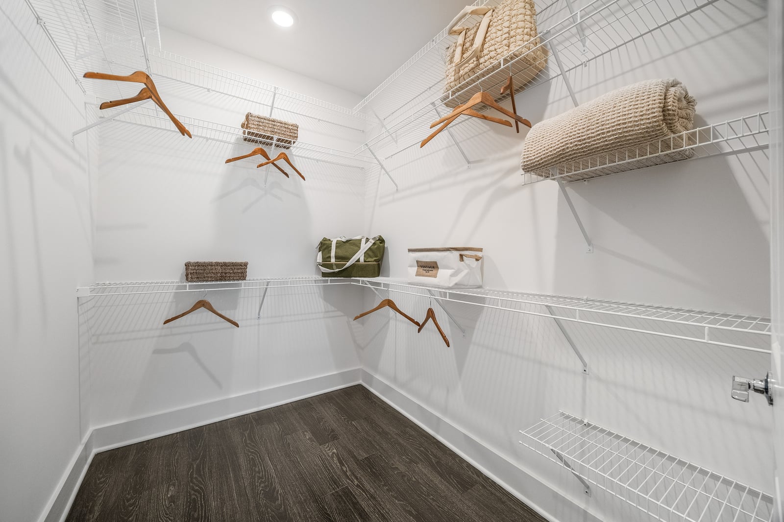 Edgewood walk-in closet with wire shelving and hanging rods