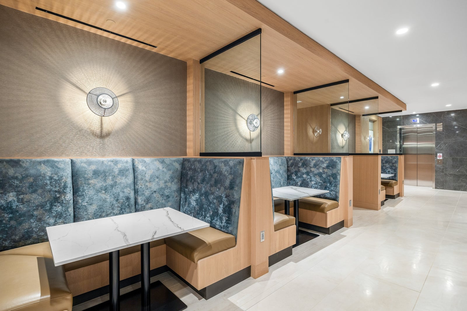 Edgewood lobby booth seating with marble tables and millwork panels