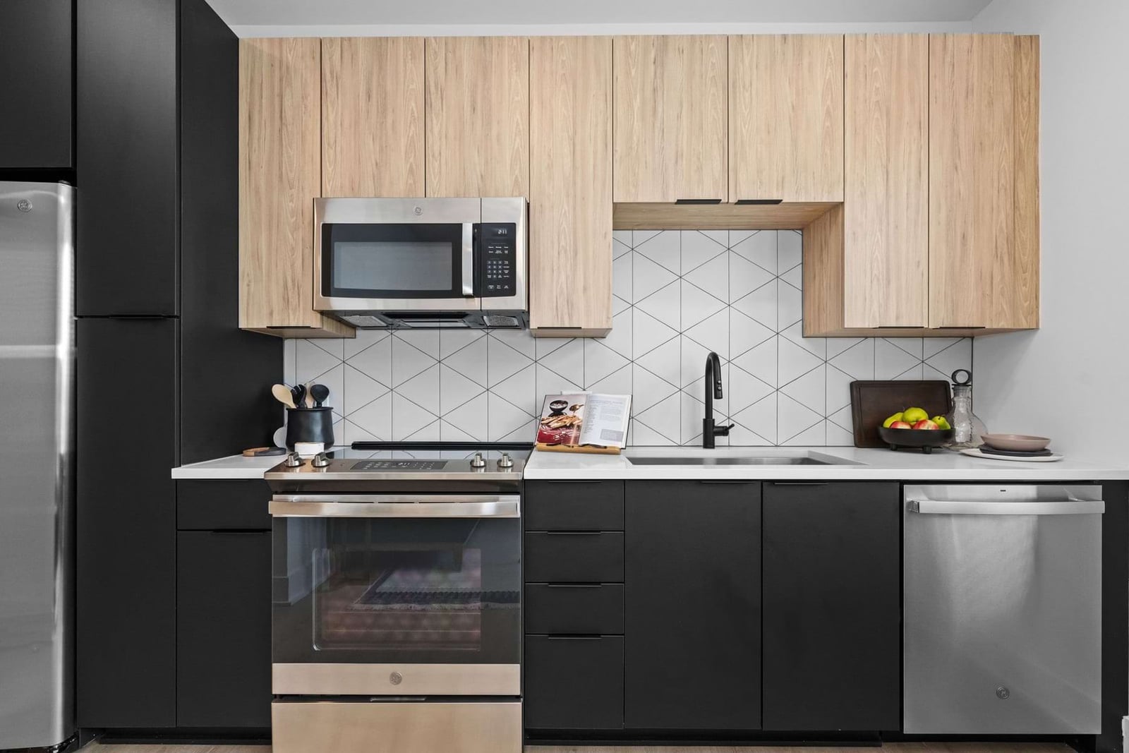 Elan LoSo kitchen with dual-tone cabinets and geometric tile backsplash