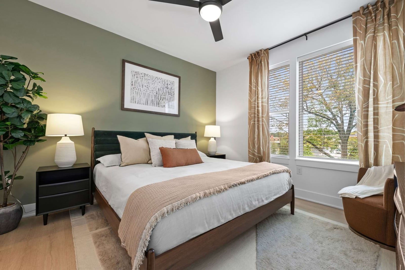 Elan LoSo bedroom with a sage accent wall