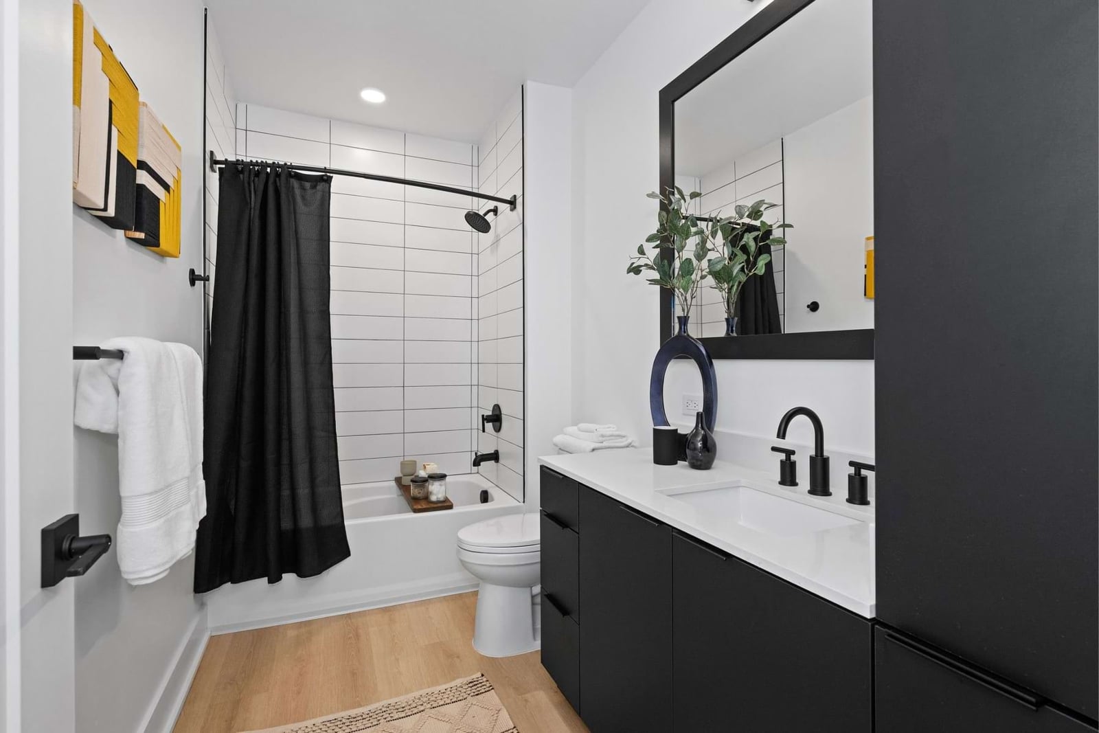 Elan LoSo bath with black vanity and subway tile tub surround