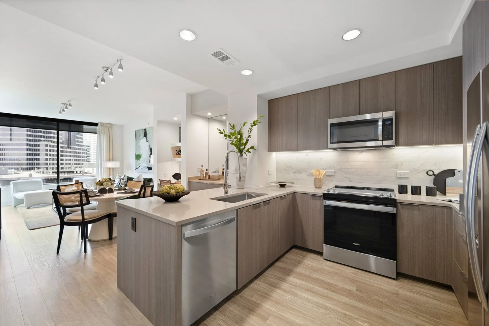 Midtown U-shaped kitchen with brown wood cabinetry and stone counters