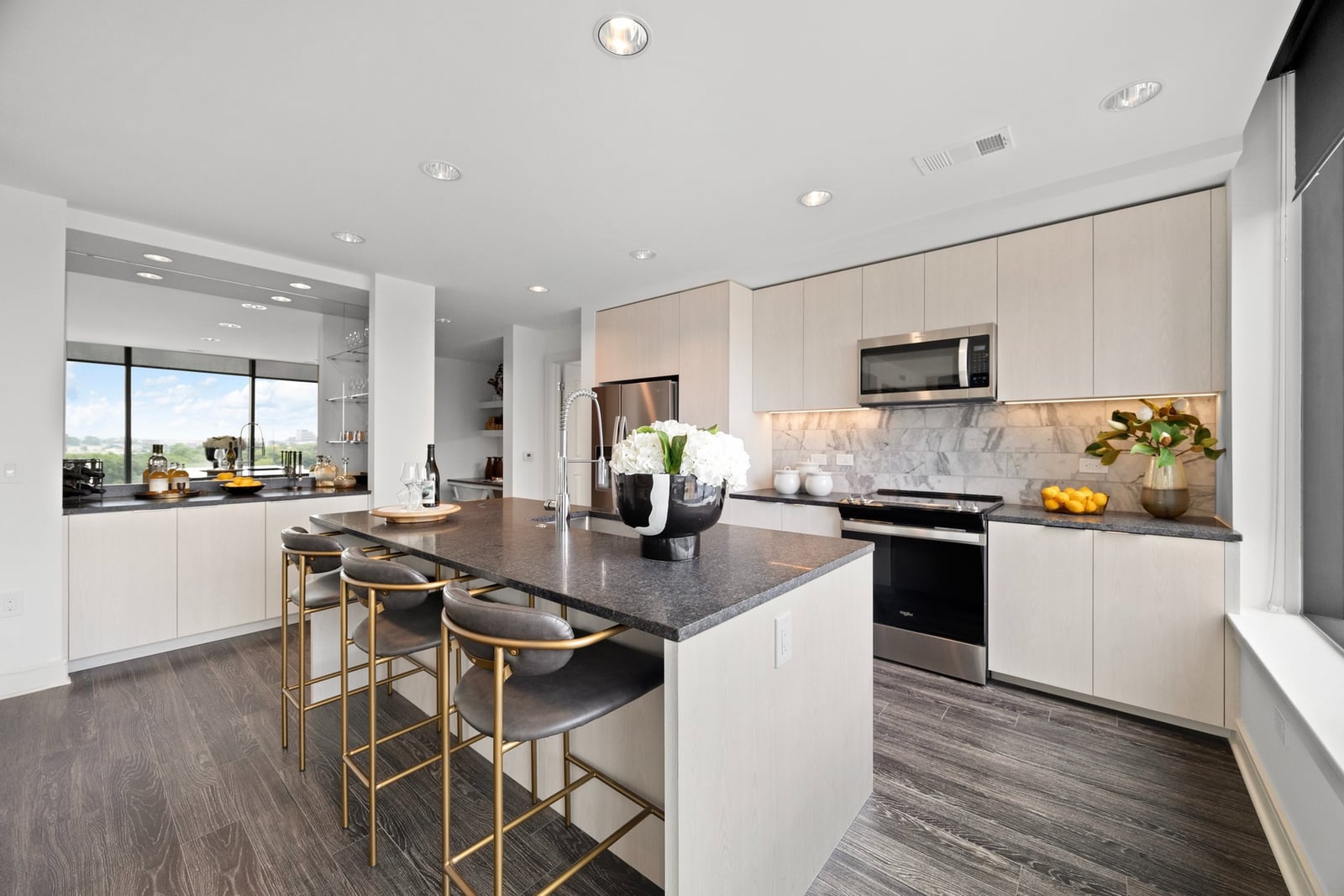 Midtown kitchen with center island, light wood cabinets and built-in dry bar