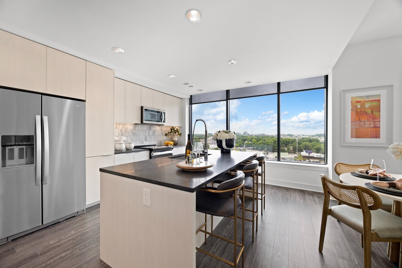 Midtown kitchen island with black stone counters and a window wall
