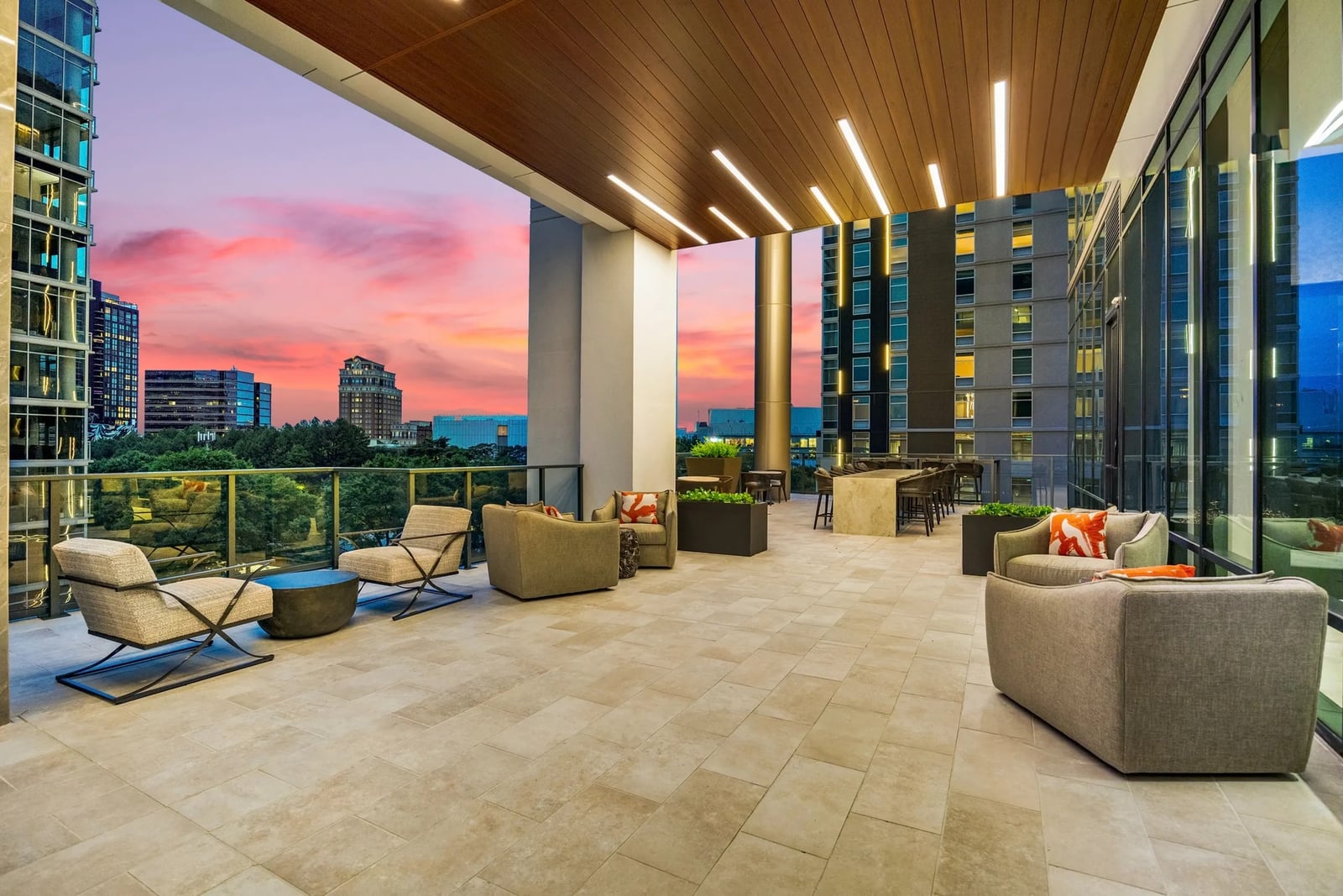 Midtown covered terrace with lounge and dining areas at sunset