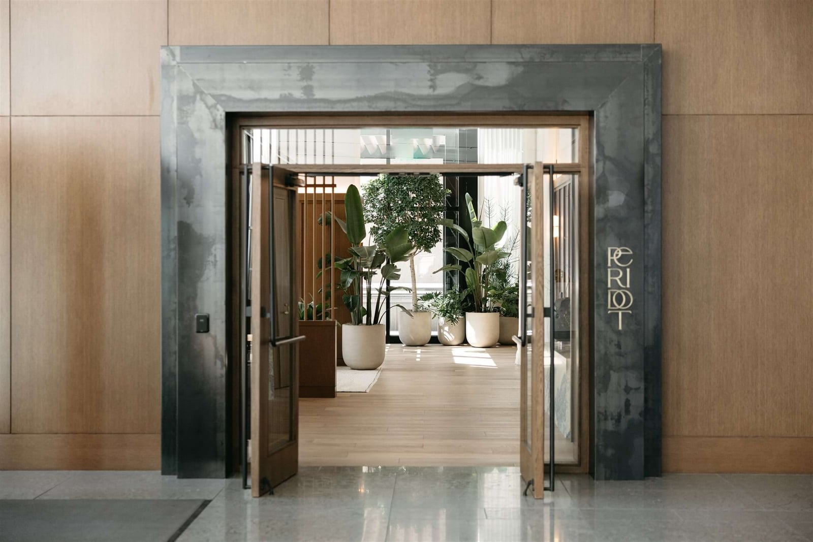 Peridot Residences lounge entry with wood-paneled walls