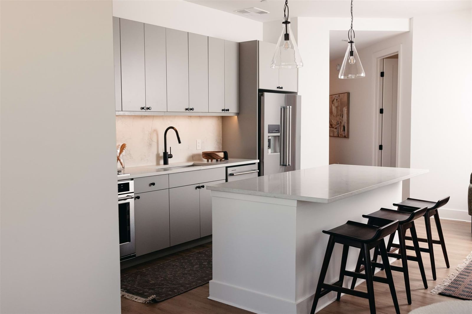 Peridot Residences kitchen with flat-panel cabinetry and quartz island