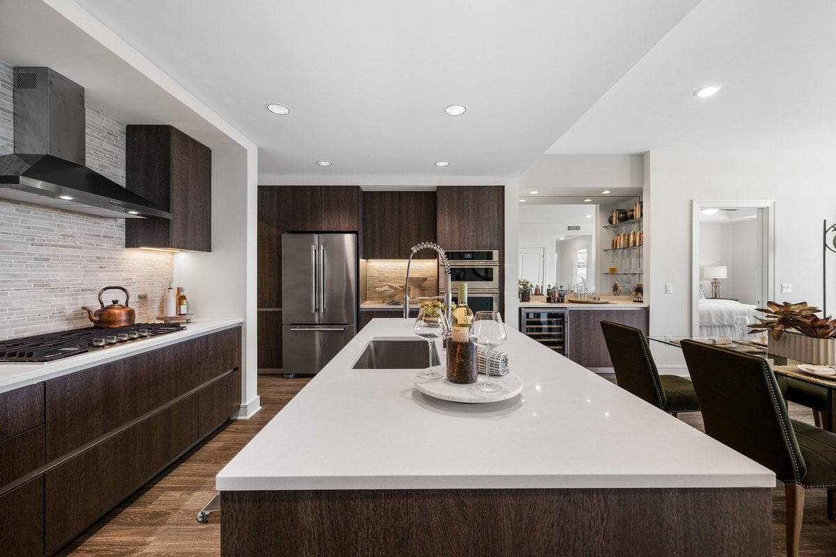 Preston Hollow kitchen with dark wood cabinets and a long island