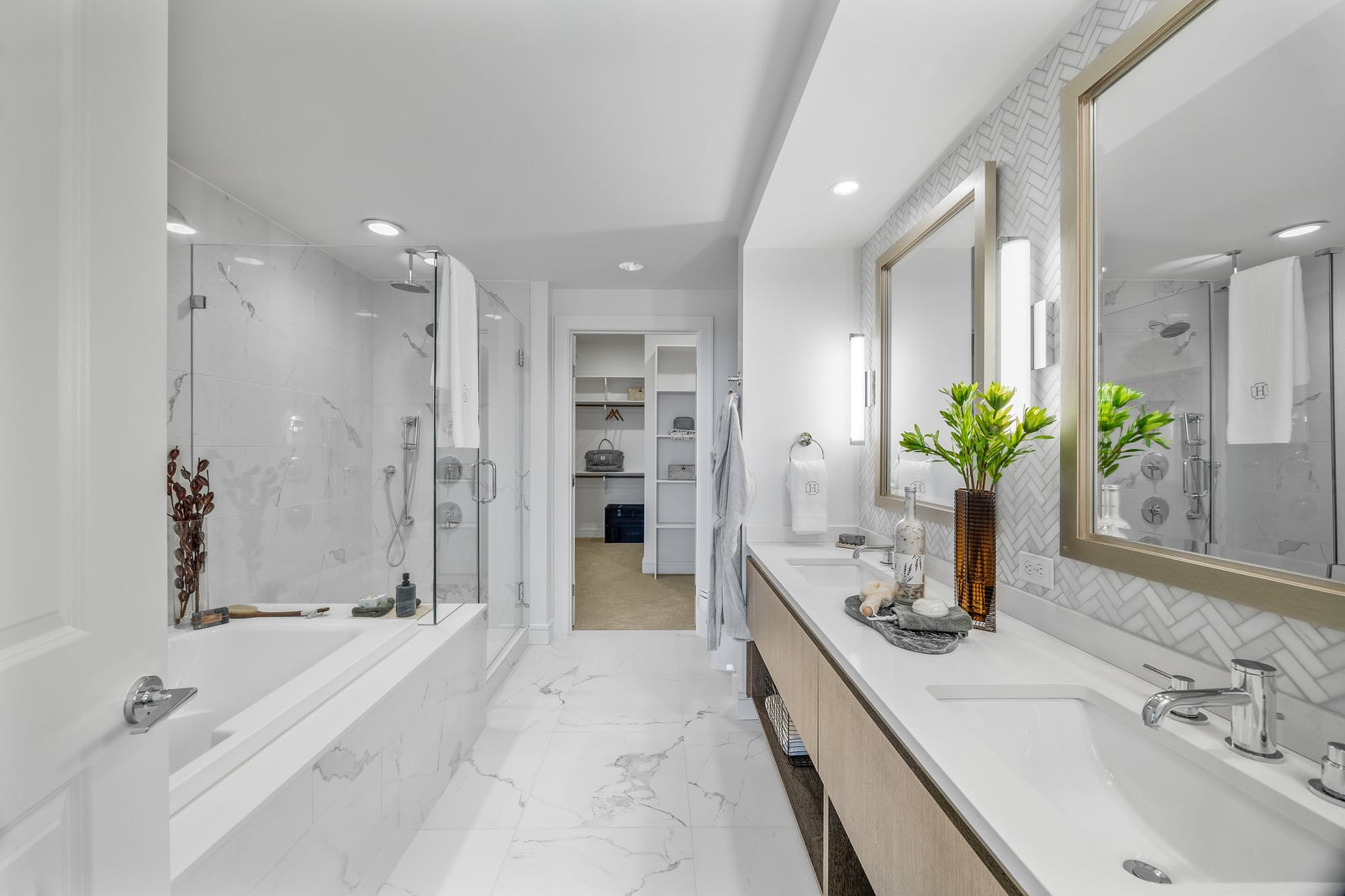 Preston Hollow bathroom with double vanity, soaking tub and glass shower