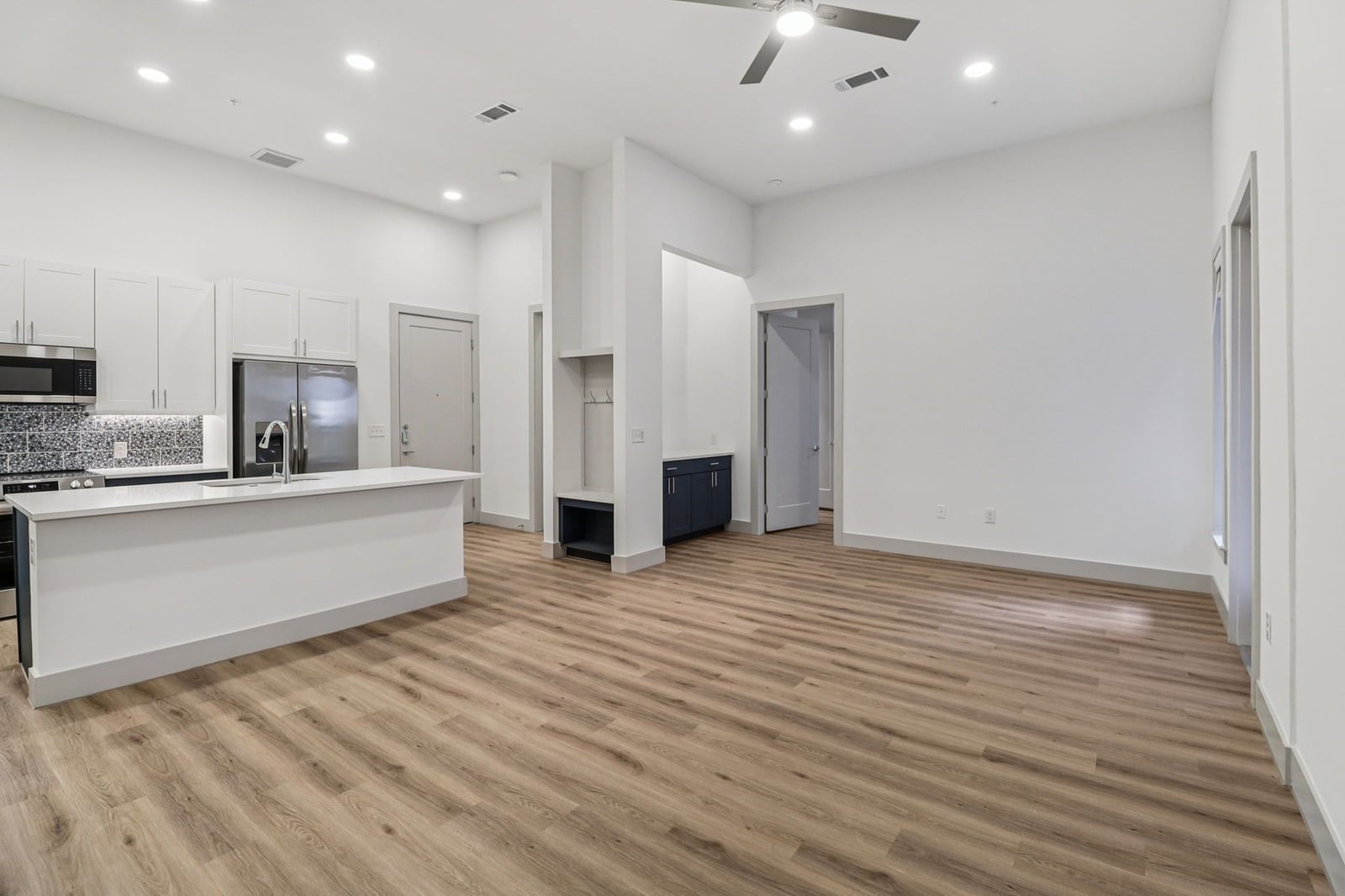 Surfside at Sapphire Bay open living area with kitchen island and entry door