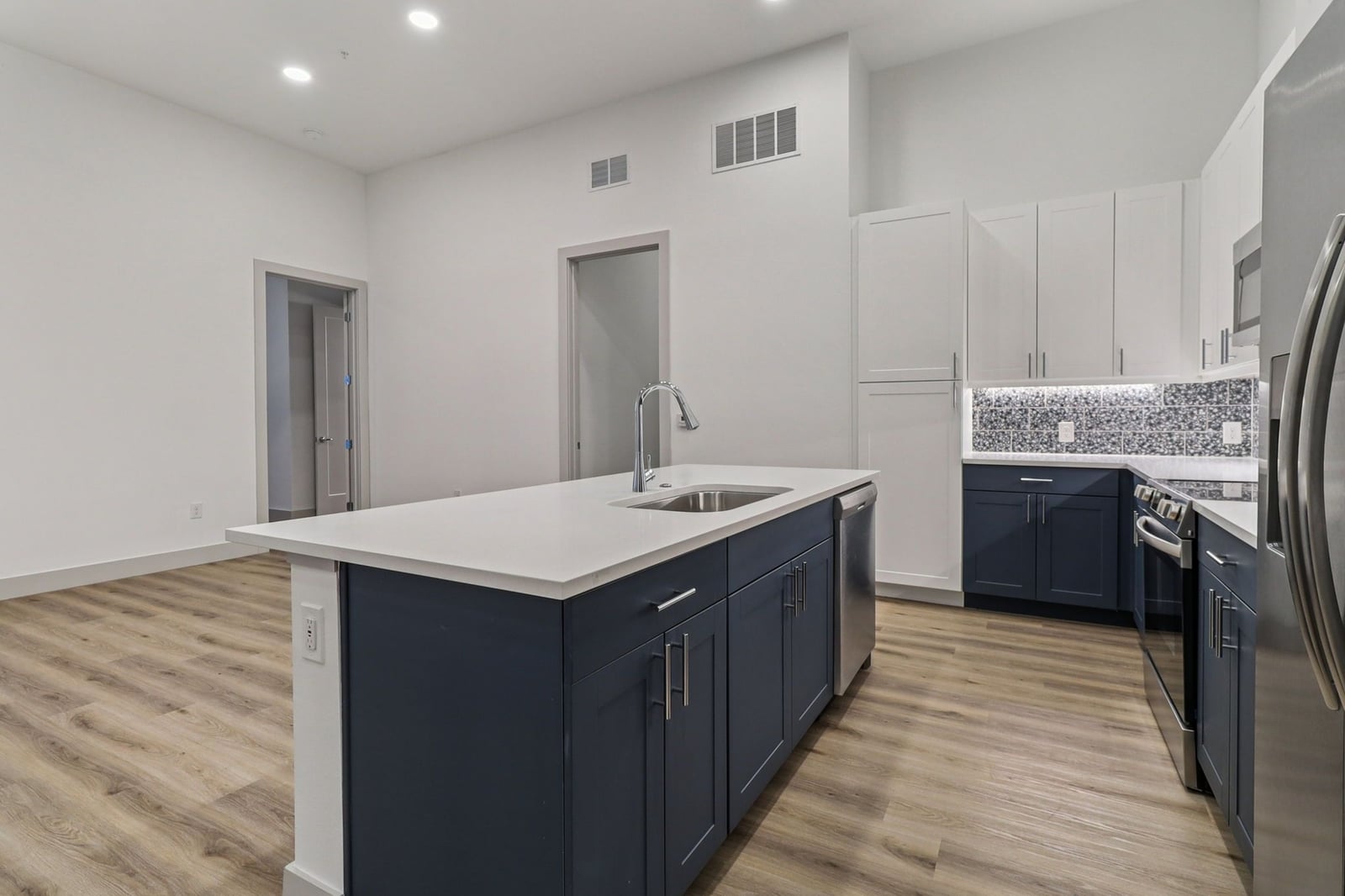 Surfside at Sapphire Bay kitchen island with navy shaker cabinets and quartz counters
