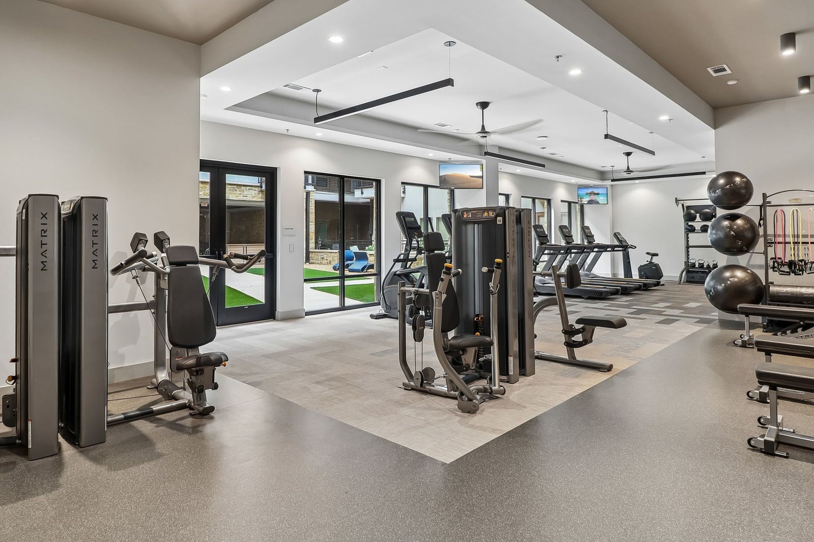 Surfside at Sapphire Bay fitness center with cardio row and courtyard doors