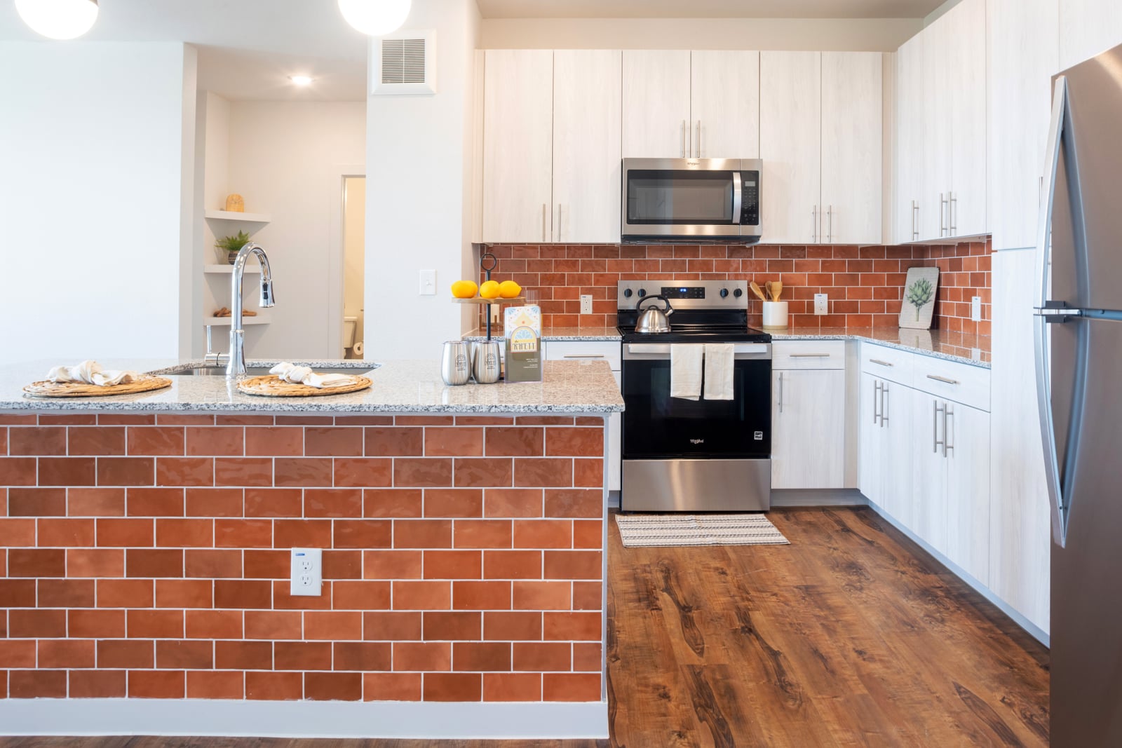 The Rhett kitchen with terracotta tile island and light wood cabinets