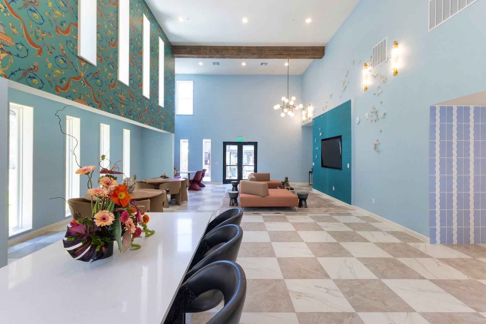 The Rhett clubhouse lounge with checkerboard floor and teal accent wall