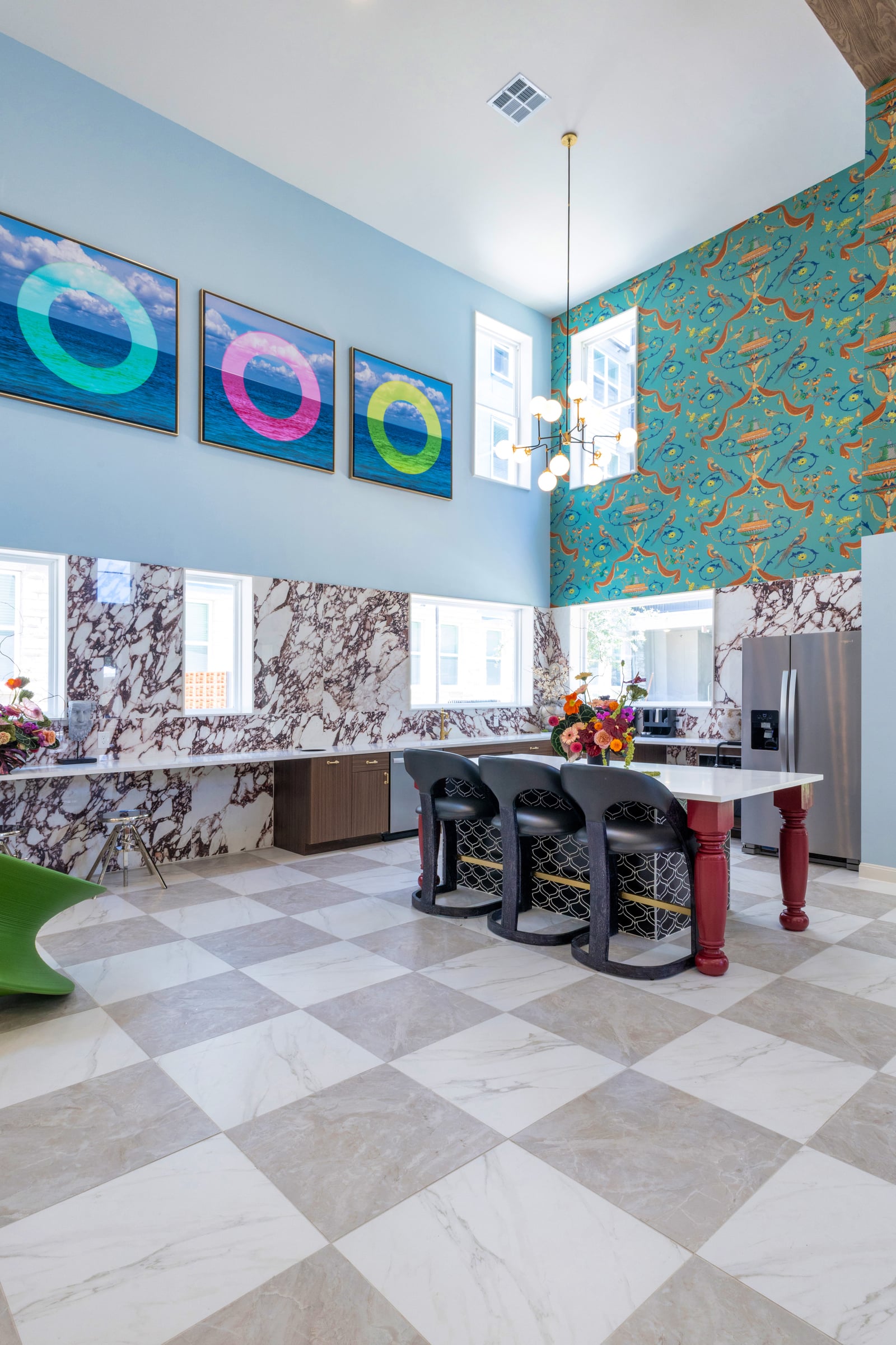 The Rhett clubhouse kitchen with marble backsplash and patterned wallpaper