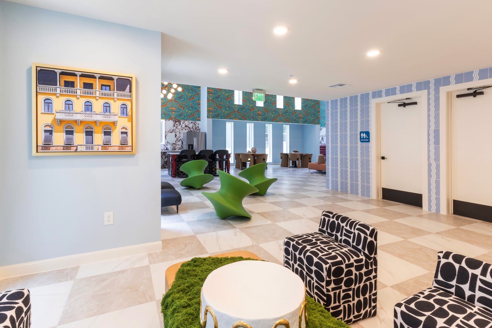 The Rhett resident lounge with patterned seating and blue tile wall