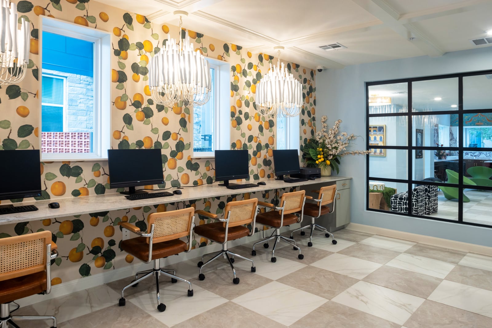 The Rhett business center with computer stations and citrus wallpaper