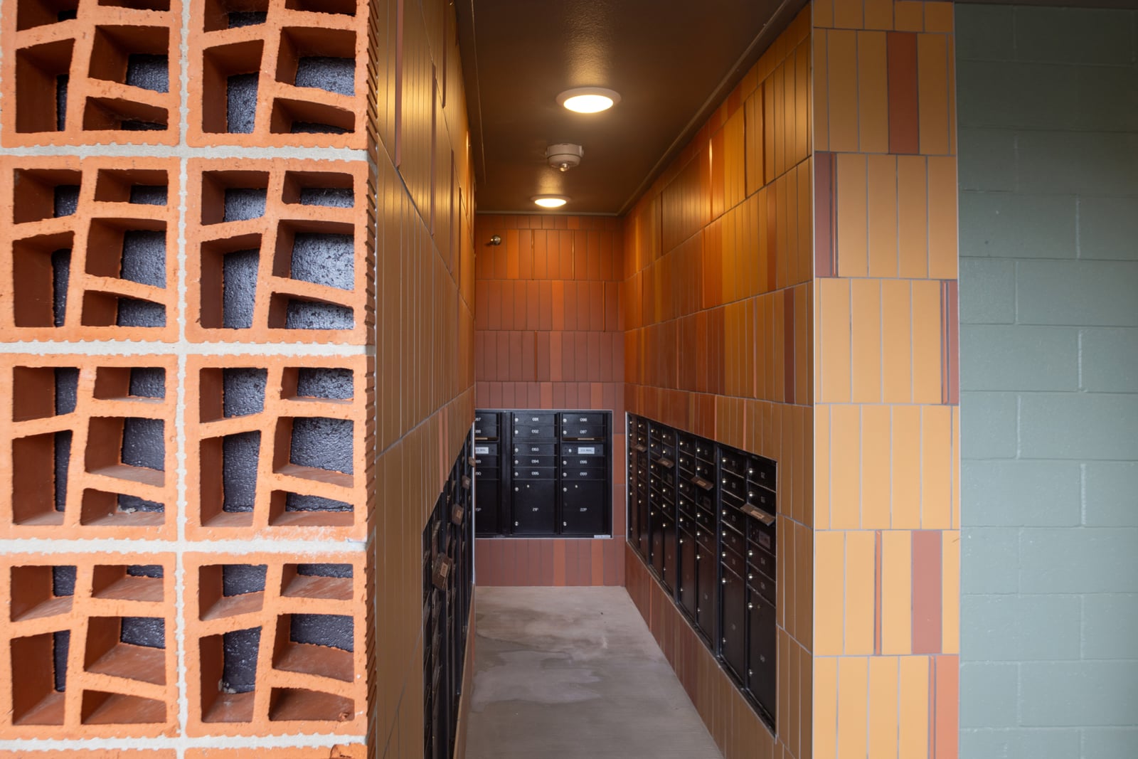 The Rhett mail room with orange tile and parcel lockers