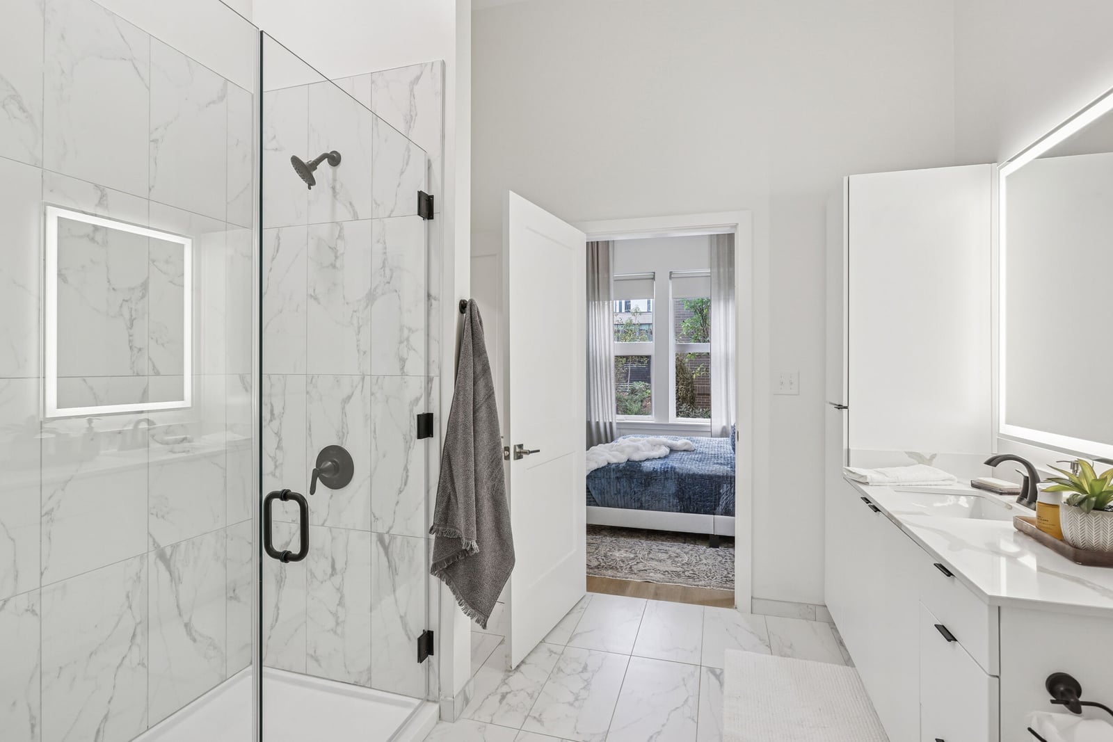 Wellory Living bath with marble-look tile and frameless glass shower