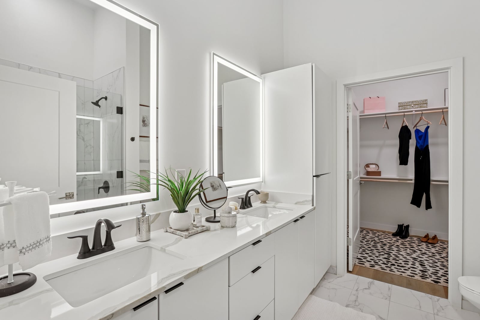 Wellory Living bath with double vanity, lighted mirrors and walk-in closet
