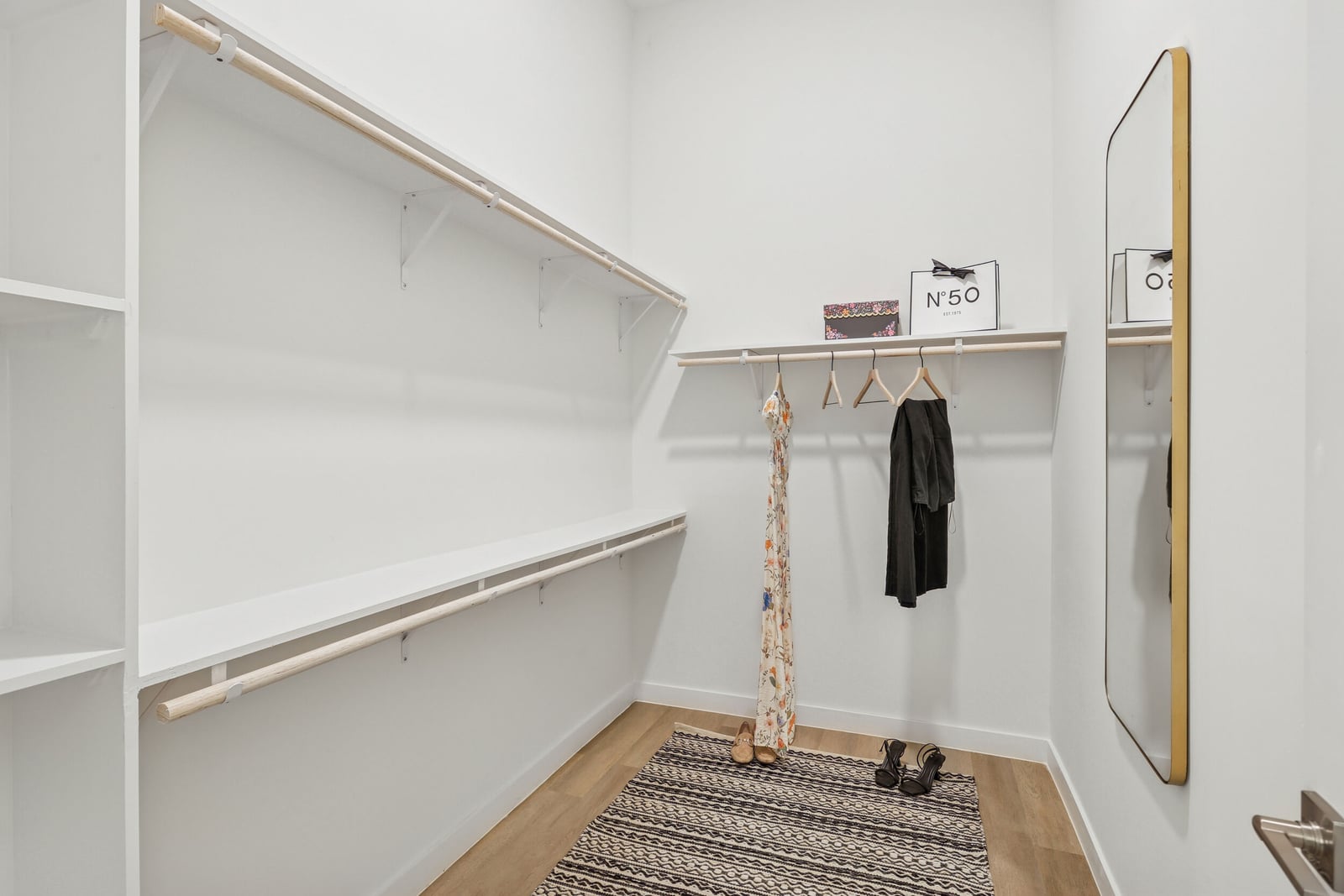 Wellory Living walk-in closet with wood rods and shelving
