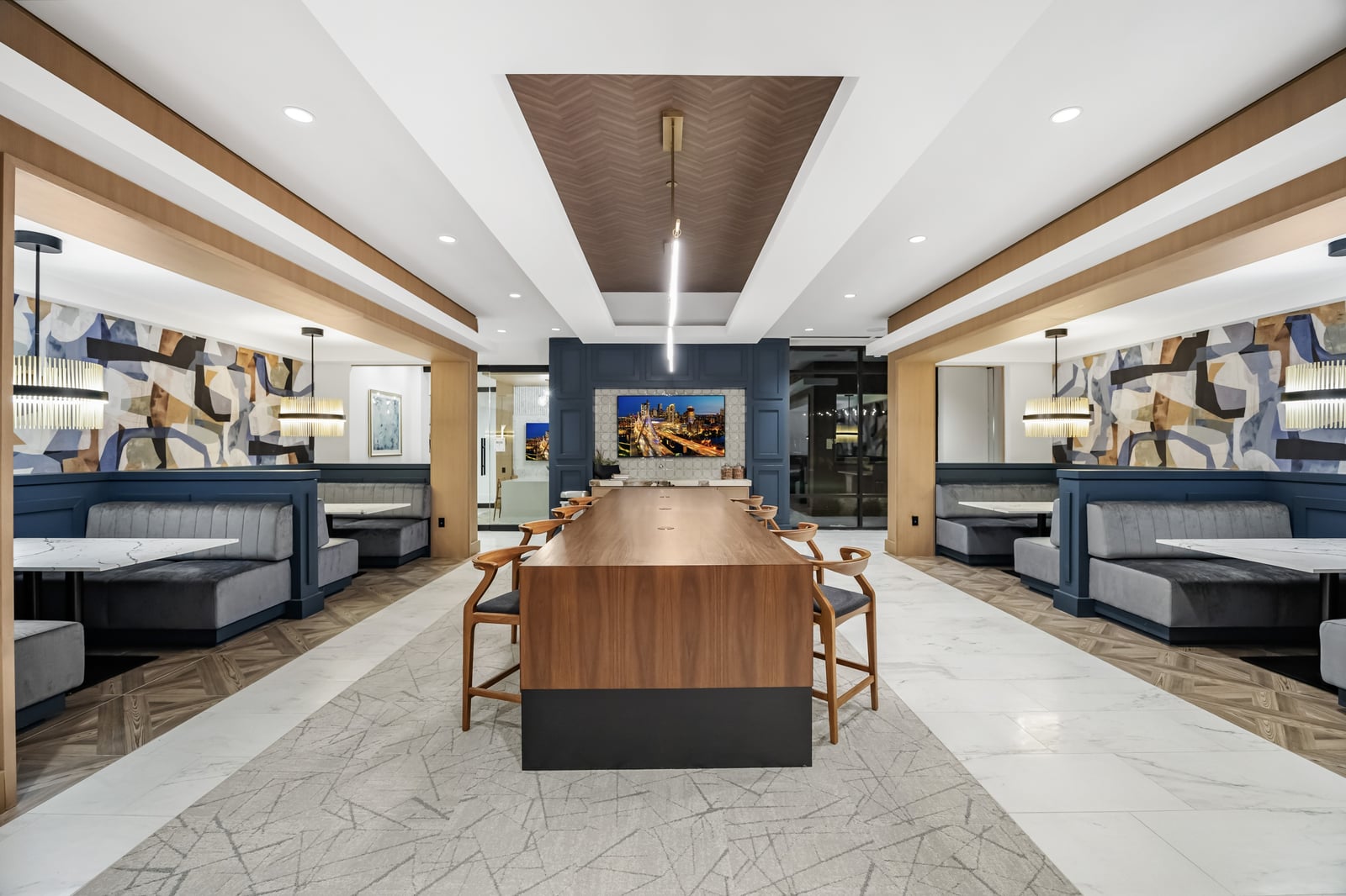 Weymouth coworking lounge with communal table and booth seating